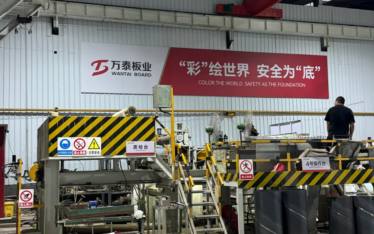 Wantai Board color-coating production line with safety signage and an operator at the control platform